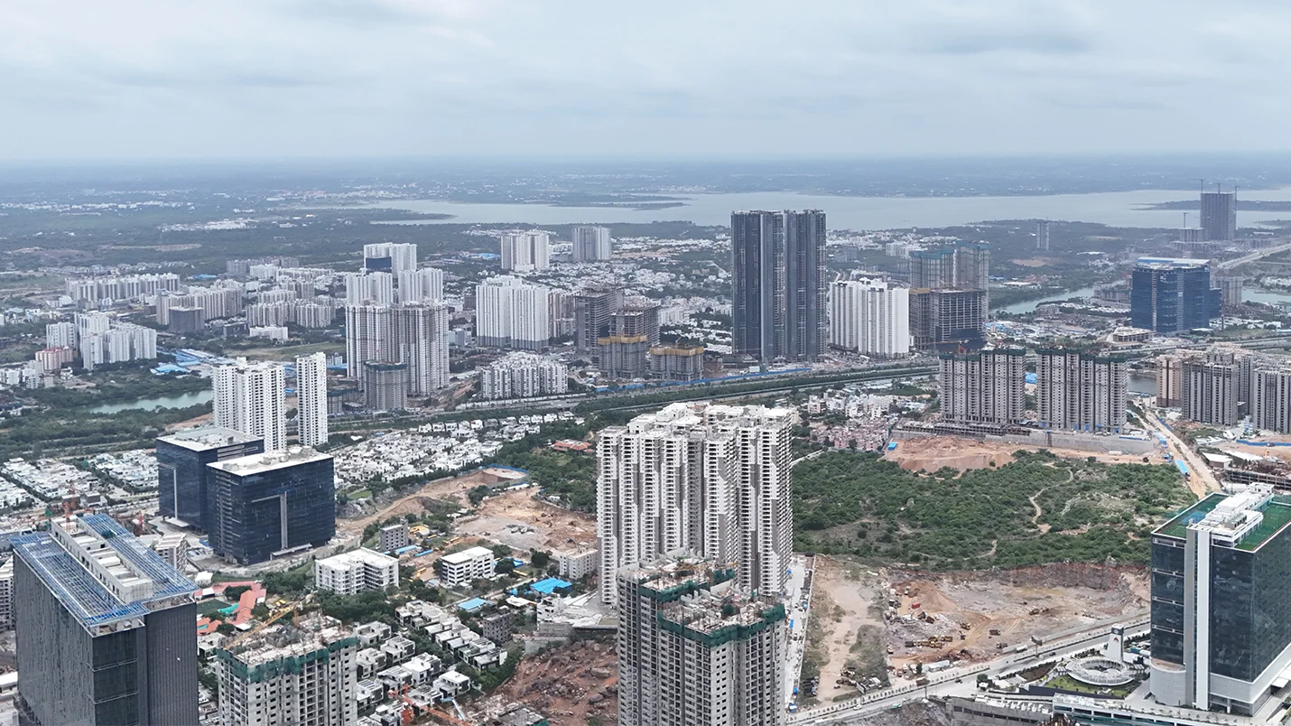Aerial view of Hyderabad’s urban skyline with high-rise residential and commercial developments under construction.