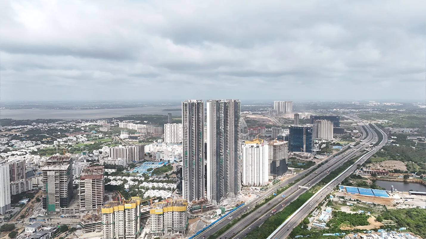 Aerial view of Kokapet with high-rise residential and commercial developments along a major highway in Hyderabad.